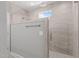 Large walk-in shower with gray tile, rainfall shower head and a glass partition at 35 Wheatfield Ln, Youngsville, NC 27596