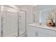 Modern bathroom features a glass-enclosed shower and a vanity with a bright mirror at 523 Old Battle Bridge Rd, Wendell, NC 27591