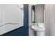 This bathroom features a pedestal sink, white walls, and a modern vanity at 523 Old Battle Bridge Rd, Wendell, NC 27591
