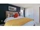 Modern bedroom features a decorative wall, nightstand, and a large comfortable bed at 523 Old Battle Bridge Rd, Wendell, NC 27591