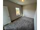 Bright bedroom with plush carpeting and natural light from the window at 55 E Victory View. Ter, Smithfield, NC 27577