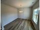 Well-lit dining room featuring sleek wood floors and a contemporary chandelier at 55 E Victory View. Ter, Smithfield, NC 27577