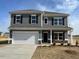 Charming two-story home with gray siding and a spacious two-car garage at 55 E Victory View. Ter, Smithfield, NC 27577