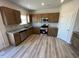Modern kitchen featuring stainless steel appliances, granite countertops, and wooden cabinetry at 55 E Victory View. Ter, Smithfield, NC 27577