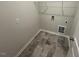 Functional laundry room featuring sleek tile flooring and storage solutions at 55 E Victory View. Ter, Smithfield, NC 27577