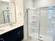 Bathroom features a double vanity with quartz countertop and a glass-enclosed shower at 62 Blue Iris Pkwy # 125, Clayton, NC 27520