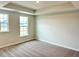Bedroom with neutral carpet, tray ceiling, recessed lighting, and lots of natural light at 62 Blue Iris Pkwy # 125, Clayton, NC 27520