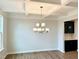 Dining room features a coffered ceiling, stylish chandelier, and a dark bar with a tile backsplash at 62 Blue Iris Pkwy # 125, Clayton, NC 27520