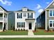 Charming two-story home featuring black shutters, a manicured lawn, and a welcoming black front door at 62 Blue Iris Pkwy # 125, Clayton, NC 27520