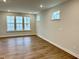 Spacious living room with hardwood floors, recessed lighting, and multiple windows at 62 Blue Iris Pkwy # 125, Clayton, NC 27520