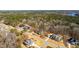 An aerial view shows the neighborhood's beautiful homes, mature trees, and proximity to a lake at 7212 Summer Tanager Trl, Raleigh, NC 27614