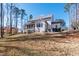 Spacious backyard featuring a screened porch and a gravel seating area, ideal for relaxation and entertaining at 7212 Summer Tanager Trl, Raleigh, NC 27614