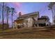 Expansive backyard with a screened porch and a gravel seating area, offering ample space for recreation at 7212 Summer Tanager Trl, Raleigh, NC 27614