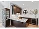 Bar area featuring a marble countertop, dark cabinets, a wine fridge, decor, and recessed lighting at 7212 Summer Tanager Trl, Raleigh, NC 27614