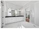 Spacious bathroom featuring dual sinks, an oversized mirror, and a soaking tub at 7212 Summer Tanager Trl, Raleigh, NC 27614