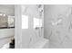 Luxurious walk-in shower features marble tile, built-in bench, and dual shower heads at 7212 Summer Tanager Trl, Raleigh, NC 27614