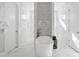 Elegant bathroom with a soaking tub, dual shower heads and floor-to-ceiling marble at 7212 Summer Tanager Trl, Raleigh, NC 27614