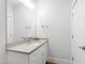 Bathroom features a light countertop and vanity, a mirror, fixtures, and bright lighting at 7212 Summer Tanager Trl, Raleigh, NC 27614