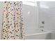 Bathroom featuring bathtub with white subway tile surround and multicolored shower curtain at 7212 Summer Tanager Trl, Raleigh, NC 27614