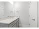 Bathroom featuring light gray vanity with light countertop, large mirror, and white walls at 7212 Summer Tanager Trl, Raleigh, NC 27614