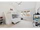 Bedroom features a white bunk bed, carpet flooring, a fan, and windows that offer natural light at 7212 Summer Tanager Trl, Raleigh, NC 27614