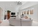 Bonus room features a large sectional sofa, lots of windows, a ceiling fan, and a playful treehouse themed area at 7212 Summer Tanager Trl, Raleigh, NC 27614