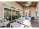 Inviting covered porch featuring stylish furniture and sliding glass doors for seamless indoor-outdoor living at 7212 Summer Tanager Trl, Raleigh, NC 27614