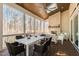 Relaxing covered porch features a stone fireplace and dining area for enjoying the outdoors at 7212 Summer Tanager Trl, Raleigh, NC 27614