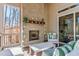 Serene covered porch with stone fireplace, comfortable seating, and peaceful views at 7212 Summer Tanager Trl, Raleigh, NC 27614