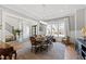 Formal dining room with a hardwood floor, tray ceiling, large windows and a view into the entryway at 7212 Summer Tanager Trl, Raleigh, NC 27614