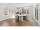Bright dining area with a large window showcasing outdoor views, complemented by an elegant chandelier at 7212 Summer Tanager Trl, Raleigh, NC 27614