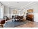 Elegant dining room with hardwood floors, a modern light fixture, and large windows providing natural light at 7212 Summer Tanager Trl, Raleigh, NC 27614