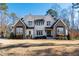 Inviting two-story home with a manicured front lawn and elegant architectural details at 7212 Summer Tanager Trl, Raleigh, NC 27614