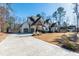 Beautiful two-story home with a three-car garage and long driveway, set on a well-maintained lawn at 7212 Summer Tanager Trl, Raleigh, NC 27614