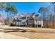 Elegant two-story home with a well-manicured lawn and a mix of stone and siding accents at 7212 Summer Tanager Trl, Raleigh, NC 27614