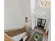 Bright foyer features hardwood floors, a decorative chandelier, staircase, and views of the front door and entry at 7212 Summer Tanager Trl, Raleigh, NC 27614