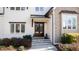Close-up of the home's entryway showcasing a wooden front door and stone steps surrounded by manicured landscaping at 7212 Summer Tanager Trl, Raleigh, NC 27614
