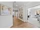 Hallway features wood floors, built-in bookshelves, white trim, and access to other rooms in the home at 7212 Summer Tanager Trl, Raleigh, NC 27614