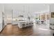 Beautiful kitchen with white cabinets, an island with seating, stainless steel appliances, and an adjacent dining area at 7212 Summer Tanager Trl, Raleigh, NC 27614