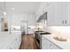 Gourmet kitchen with a large island, professional-grade appliances, and sleek white countertops at 7212 Summer Tanager Trl, Raleigh, NC 27614