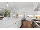 Contemporary kitchen featuring a large island, stainless steel appliances, and hardwood floors at 7212 Summer Tanager Trl, Raleigh, NC 27614