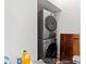 Laundry room featuring stacked washer and dryer and household cleaning supplies at 7212 Summer Tanager Trl, Raleigh, NC 27614