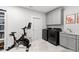 Functional laundry room with gray cabinets, utility sink, and modern washer and dryer at 7212 Summer Tanager Trl, Raleigh, NC 27614
