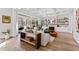 Beautiful living room featuring a fireplace with shelving, hardwood floors, and sliding glass doors to the outside at 7212 Summer Tanager Trl, Raleigh, NC 27614