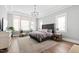 Tranquil main bedroom featuring large windows and a plush king bed, creating a relaxing retreat at 7212 Summer Tanager Trl, Raleigh, NC 27614