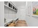 Well-organized mudroom with built-in bench, storage, and desk, perfect for managing household items at 7212 Summer Tanager Trl, Raleigh, NC 27614