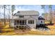 Back exterior featuring a screened porch, patio with fire pit, and ample yard space at 7212 Summer Tanager Trl, Raleigh, NC 27614