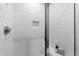 Modern shower featuring white subway tile, built-in niche, shower caddy, and glass doors at 7212 Summer Tanager Trl, Raleigh, NC 27614
