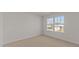 Cozy bedroom with plush carpeting, a large window offering lots of natural light at 832 Canis Minor Rd, Wendell, NC 27591