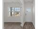 Inviting entryway featuring a white door with glass panels and durable wood-look flooring at 832 Canis Minor Rd, Wendell, NC 27591